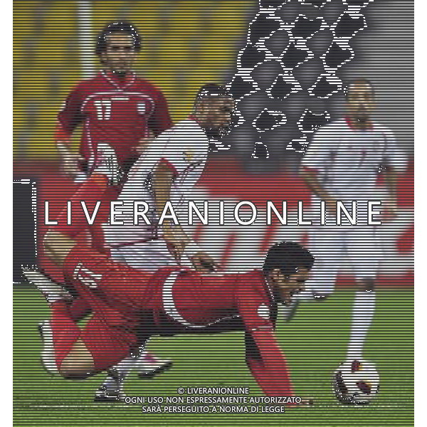 (110115) -- DOHA, Jan. 19, 2011 () -- Iranian player Mohamamd Gholami (Under) falls down during the Asian Cup group D soccer match against the United Arab Emirates (UAE) in Doha, capital of Qatar, Jan. 19, 2011. Iran beat UAE 3-0. (/Tao Xiyi) (wjd) COPPA D\'ASIA 2011 GRUPPO D IRAN VS EMIRATI ARABI UNITI AG. ALDO LIVERANI SAS ITALY ONLY