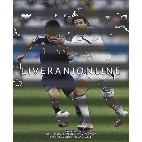 (110121) -- DOHA, Jan. 21, 2011 () -- Yasuyuki Konno (L) of Japan vies with Sebastian Suria of Qatar during the 2011 Asian Cup quarter-final football match in Doha, capital of Qatar, Jan. 21, 2011. (/Tao Xiyi) /PHOTOSHOT/AG ALDO LIVERANI SAS - ASIAN CUP 2011 ITALY ONLY