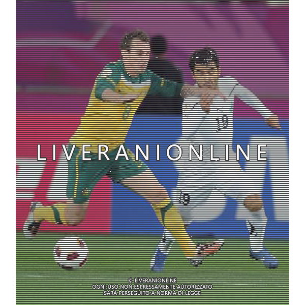 (110125) -- DOHA, Jan. 25, 2011 () -- Australia\'s Luke Wilkshire (L) vies with Uzbekistan\'s Jasur Khasanov during the Asian Cup semifinal between Uzbekistan and Australia in Doha, capital of Qatar, Jan. 25, 2011. Australia won 6-0 and advanced to the final. (/Chen Shaojin) (zw) Doha Coppa d\'Asia 2011 Uzbekistan vs Australia AG. ALDO LIVERANI SAS ITALY ONLY