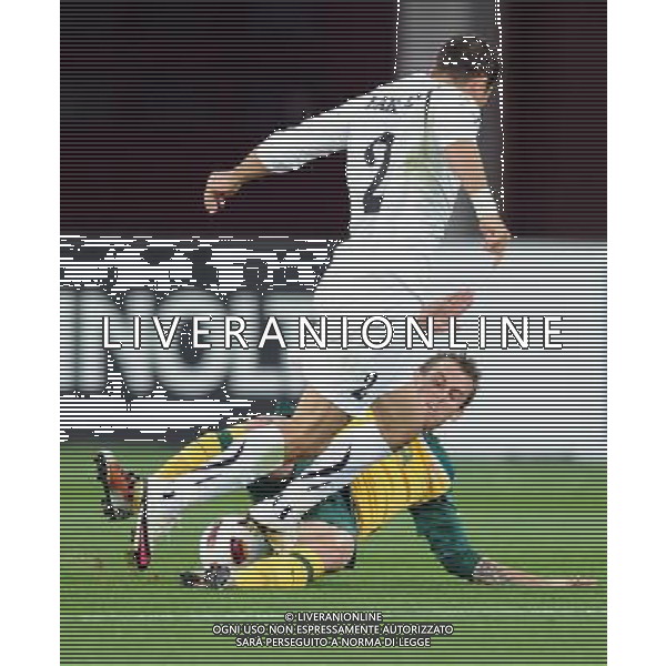 (110125) -- DOHA, Jan. 25, 2011 () -- Australia\'s Luke Wilkshire (below) vies with Uzbekistan\'s Ulugbek Bakayev during the Asian Cup semifinal between Uzbekistan and Australia in Doha, capital of Qatar, Jan. 25, 2011. Australia won 6-0 and advanced to the final. (/Chen Shaojin) (zw) Doha Coppa d\'Asia 2011 Uzbekistan vs Australia AG. ALDO LIVERANI SAS ITALY ONLY