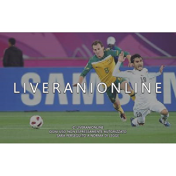 (110125) -- DOHA, Jan. 25, 2011 () -- Australia\'s Luke Wilkshire (L) vies with Uzbekistan\'s Jasur Khasanov during the Asian Cup semifinal between Uzbekistan and Australia in Doha, capital of Qatar, Jan. 25, 2011. Australia won 6-0 and advanced to the final. (/Chen Shaojin) (zw) Doha Coppa d\'Asia 2011 Uzbekistan vs Australia AG. ALDO LIVERANI SAS ITALY ONLY