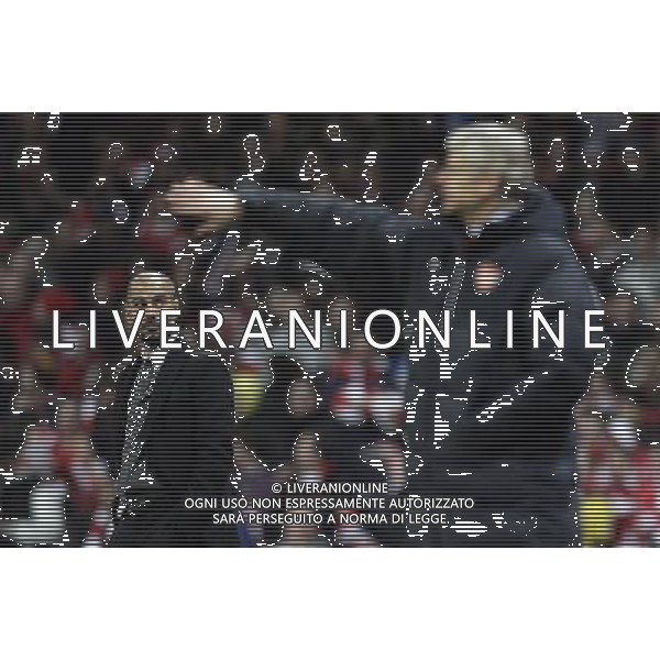 Barcelona\'s manager Josep Guardiola (left) looks on as Arsenal\'s manager Arsene Wenger directs their players during the UEFA Champions League first round of 16 match between Arsenal and Barcelona FC in the Emirates Stadium, north London, Britain, 16 February 2011. AG. ALDO LIVERANI SAS ITALY ONLY