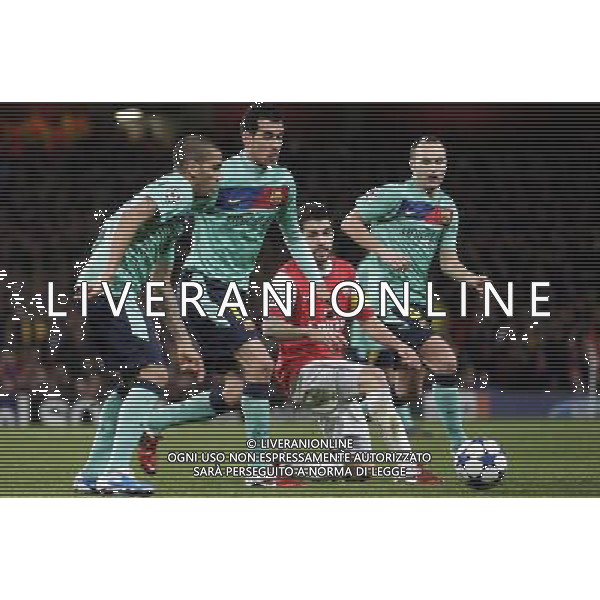 Arsenal\'s Cesc Fabregas eyes the ball between three Barcelona players during the UEFA Champions League first round of 16 match between Arsenal and Barcelona FC in the Emirates Stadium, north London, Britain, 16 February 2011. AG. ALDO LIVERANI SAS ITALY ONLY