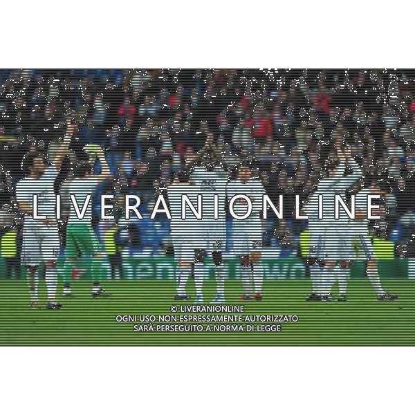 (110317) -- MADRID, March 17, 2011 () -- With T-shirts writing \'ANIMO ABIDAL\' (Go Abidal in English), players of Real Madrid greet the audience for their lineup for the quarterfinals after the match against Olympique Lyon at the 2010/11 UEFA Champions League at Santiago Bernabeu Stadium in Madrid on March 16, 2011. The players were wearing T-shirts wishing Barcelona\'s player Eric Abidal a prompt recovery. Abidal, who has been diagnosed with liver cancer, will undergo surgery on March 17. Madrid defeated Lyon by 3-0. On aggregate 4-1, Real Madrid completed the lineup for quarter finals. (/Chen Haitong) (lm) AG ALDO LIVERANI S A S ONLY ITALY