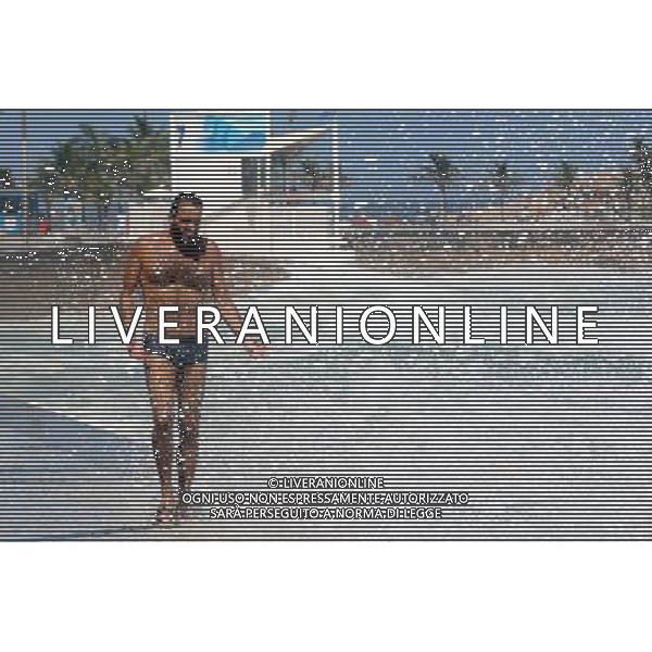 (110317) -- RIO DE JANEIRO, March 17, 2011 () -- A man walks next to a wave at Arpoador Beach, in Rio de Janeiro, Brazil, on March 16, 2011. Strong winds and an extratropical cyclone created rough seas off the southeast coast of Brazil. (/Agencia Estado)(BRAZIL OUT) (ce) AG. ALDO LIVERANI SAS ITALY ONLY *** Local Caption *** .