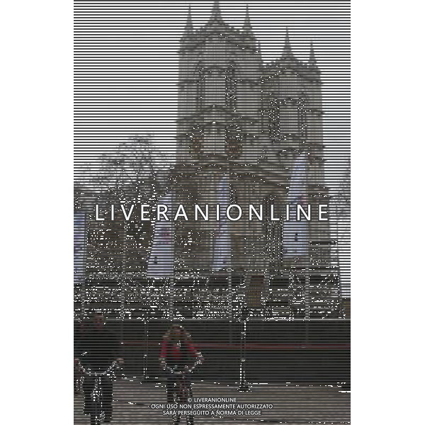 LONDON, April 3, 2011 Cyclists ride past the media stand outside the Westminster Abby, venue of the upcoming royal wedding in London, Britain, April 3, 2011. Preparation work continued along the Buckingham Palace to Westminster Abbey as April 29, the day when Prince William is going to marry Kate Middleton, drew near. The royal wedding was expecting an audience of over one billion across the world. (/Bimal Gautam) AG. ALDO LIVERANI SAS ITALY ONLY *** Local Caption *** .