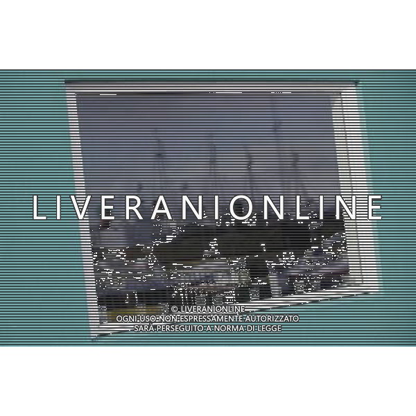 Fishing ships are reflected on the window of restaurant in the old harbour of ReykjavÕk, Iceland, 6 April 2011. Recovering from the financial crisis the country will vote on a referendum on 9 April 2011 wether to accept the conditions to pay back the debt of millions to the UK. A previous referendum on 6 March 2010 regarding a previous offer made by the United Kingdom and the Netherlands was defeated, with 93% voting against and less than 2% in favor of agreeing to the terms. Vedute ed immagini dell\' Islanda , con capitale Reykjavik la cui economia  \' saltata \' per colpa della crisi finanziaria che ha colpito l\'intera Europa AG.ALDO LIVERANI SAS ITALY ONLY *** Local Caption *** .