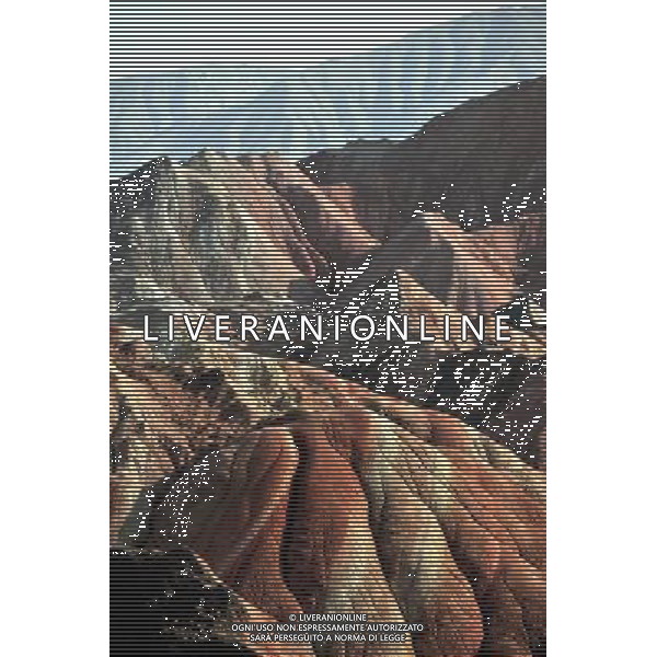 (110412) ZHANGYE, April 12, 2011 () Danxia landform is seen at a geopark near Zhangye, northwest China\'s Gansu Province, April 11, 2011. Danxia, which means \'rosy cloud,\' is a special landform formed from reddish sandstone that has been eroded over time into a series of mountains surrounded by curvaceous cliffs and many unusual rock formations. (/Gao Jianjun) (lfj) Geoparco a Zhangye , morfologia Danxia che significa \'nuvola rosa\',  una morfologia speciale formata da arenaria rossastra che  stata erosa nel tempo in una serie di montagne circondate da pareti curve formazioni rocciose insolite AG. ALDO LIVERANI SAS ITALY ONLY *** Local Caption *** .