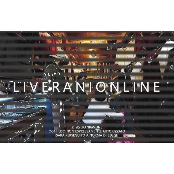 (110414) LHASA, April 14, 2011 () A family from Nakqu region try on Tibetan dress at a clothes shop on the Parkhor Street, in Lhasa, capital of southwest China\'s Tibet Autonomous Region, April 6, 2011. As one of the most distinct and attractive old blocks in the world, Parkhor Street is unique with contrastive features and stunning diversity. It is a place where Tibetan tradition meets modern fashion, religious sanctity mixes with commercial prosperity. Located in the center of Lhasa, surrounding the Jokhang Temple, it covers an area of 133.82 hectares and has 35 small streets and alleys extending in all directions. The Tibetan word Parkhor literally means \'an annular worshipping road\', which refers to the main street of the block. The main street, about two kilometers long, functions as the most important road for pilgrimage, local business, and tourism. In its 1400 years\' long history, Parkhor Street has witnessed the eclipse and prosperity of Buddhism, the exchange and fusion of the diverse cultures, the flourishing of ancient trade, the continuous changes of the regimes, and the ups and downs of Lhasa. Because of its unmatched location and cultural signification, Parkhor Street has long been considered as the epitome of Lhasa\'s historical development. It is the earliest and most prosperous business street in the city, crowded with merchants from all over China and even foreign countries such as Nepal and India, selling craftworks and products with rich ethnical features. Since the peaceful liberation of Tibet, the Parkhor Street has undergone fundamental changes. Common people moved into the former residence of noble families, handcraft workshops and stores appeared one after another, and shabby street infrastructure were thoroughly renovated. Along with China\'s Reform and Opening Up, the Parkhor Street in 1980\'s and 1990\'s saw a rise of commerce with increasing shops and abundant commodities. Tibetan artworks and craftworks gradually went p AG ALDO LIVERANI ONLY ITALY