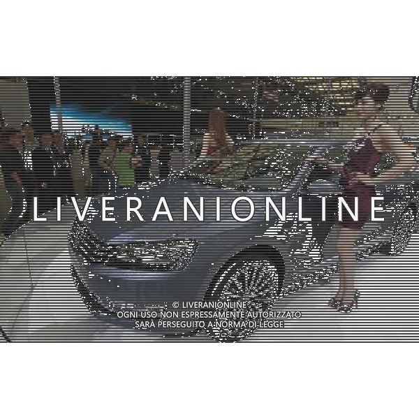 (110419) SHANGHAI, April 19, 2011 Models pose by a new Volkswagen Passat car during the press preview of the 14th Shanghai International Automobile Industry Exhibition in east China\'s Shanghai, April 19, 2011. The Exhibition, which kicked off here Tuesday, will be open to the public from April 21 to 28. About 2,000 carmakers and parts providers from 20 countries are due to showcase 1,100 car models, 75 of which makes their world premieres in the auto show. (/Pei Xin) (ljh) Anteprima per la stampa del 14mo Shanghai International Automobile Industry Exhibition AG. ALDO LIVERANI SAS ITALY ONLY *** Local Caption *** .