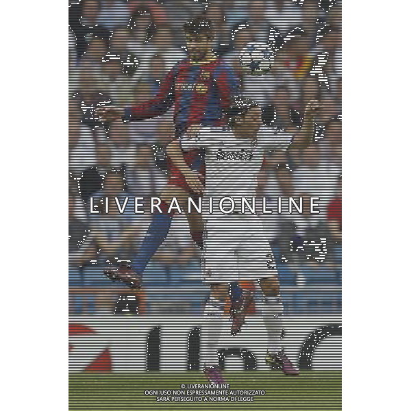 Real Madrid\'s Mesut Ozil and Barcelona\'s Gerard Pique during Champions League semifinal first match on April 27 2011. Photo: Cesar Cebolla / ALFAQUI AG. ALDO LIVERANI ONLY ITALY