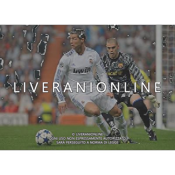 (110428) -- MADRID, April 28, 2011 () -- Cristiano Ronaldo (L) of Real Madrid controls the ball during the first leg match of Champions League semi-final against Barcelona at Santiago Bernabeu Stadium in Madrid, Spain, April 27, 2011. Real Madrid lost 0-2. (/Chen Haitong) (bxf) AG ALDO LIVERANI ONLY ITALY