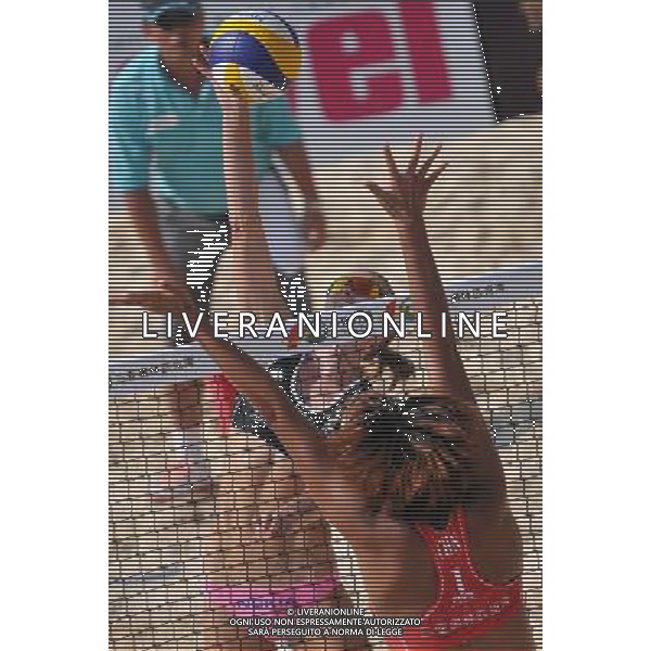 (110428) -- SANYA, April 28, 2011 () -- Emilia Nystron (central) of Finland spikes against China\'s Xue Chen and Zhang Xi during 2011 Swatch FIVB Beach Volleyball World Tour in Sanya, south China\'s Hainan Province, April 28, 2011. Xue Chen and Zhang Xi won 2-0. (/Hou Jiansen) AG ALDO LIVERANI S A S ONLY ITALY