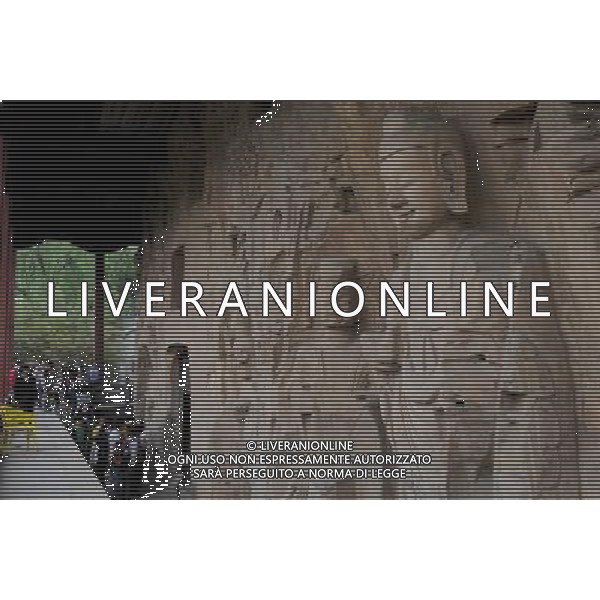 (110428) -- ZHENGZHOU, April 28, 2011 () -- Tourists visit the Gongyi Grottoes in Gongyi City of Zhengzhou, capital of central China\'s Henan Province, April 28, 2011. The Gongyi Grotto Temple, caved by the royal family of the North Wei Dynasty (386-557), has five existing grottoes and 7,743 Buddha statues. The grotto temple has become a tourist site along the Yellow River after receiving restoration and proper protection. (/Zhao Peng) (llp) Zhengzhou Foto scattata il 28 aprile 2011, mostra due statue di Buddha nella Grotta Gongyi Tempio di Gongyi cittˆ di Zhengzhou, Il tempio grotta  diventata una localitˆ turistica lungo il Fiume Giallo, dopo aver ricevuto il restauro e la protezione adeguata. AG. ALDO LIVERANI SAS ITALY ONLY *** Local Caption *** .