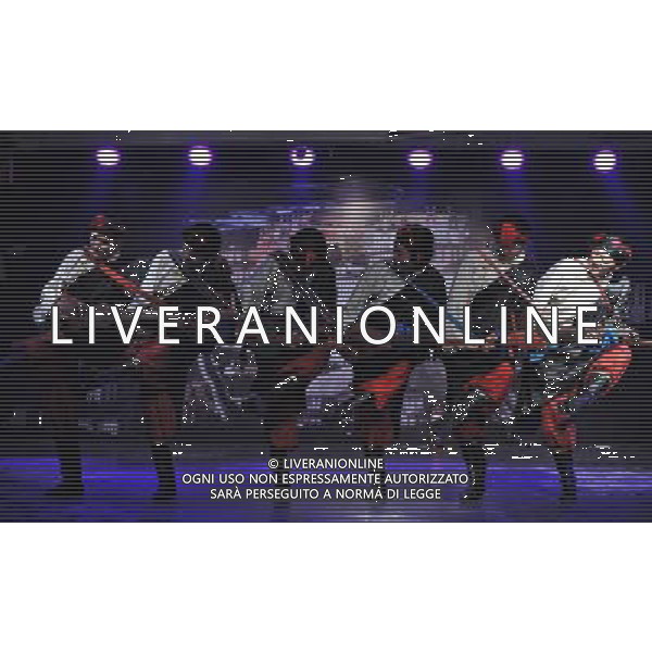 LHASA, May 9, 2011 Actors perform folk dance of Shigatse region at the New Century Langma Hall in Lhasa, capital of southwest China\'s Tibet Autonomous Region, early May 8, 2011. It was 10:30 p.m. in Lhasa. Although most of the shops and restaurants were about to close, Niwei Langma hall was just warming up. Colorful spotlights illuminated the huge backdrop painting of the Potala Palace on the stage, while delightful Tibetan melody echoed around the hall. Guests were arriving in pairs or groups and quickly filled up the entertainment place. Dainzhencao, a newcome dancer, was busy dressing herself for the opening performance. She couldn\'t stop feeling nervous until she made sure her make up, costumes and decorations were all done, as she just danced this piece for a few times. However, at another dressing room, the experienced dancers were in an easy mood, as some were playing cell phone games, gossiping, and even knitting. The word \'Langma\' in Tibetan language means courtly performance, which in the past was only an entertainment for Tibetan traditional aristocracy. However, the present langma hall eventually evolved into a place of part bar, part folk concert hall and part ballroom, where common Tibetan people go for relaxation and gathering. Since the first such place opened in the mid 1990s, Langma halls soon became quite popular all over Tibet and emerged one after another in a short time. Today, Niwei is one of the biggest Langma halls in Lhasa. Its owner Gyaebo, who used to be a famous tap dancer in Lhasa, runs four langma halls of his own. All of his langma halls perform traditional Tibetan songs and dances, but in order to cater to different taste of customers, two langma halls emphasize on modern, western dance and even disco, while the others focus on Tibetan \'guozhuang\' and tap dance. There are more than 50 actors in Niwei Langma Hall, more than half of whom are at their 20\'s. They usually work for 5 6 hours per day, and attend two h Scene di vita a Lhasa AG. ALDO LIVERANI SAS ITALY ONLY *** Local Caption *** .