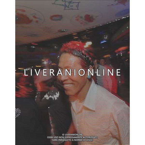 LHASA, May 9, 2011 A guest participates in \'guozhuang\' dance at the New Century Langma Hall in Lhasa, capital of southwest China\'s Tibet Autonomous Region, early May 8, 2011. It was 10:30 p.m. in Lhasa. Although most of the shops and restaurants were about to close, Niwei Langma hall was just warming up. Colorful spotlights illuminated the huge backdrop painting of the Potala Palace on the stage, while delightful Tibetan melody echoed around the hall. Guests were arriving in pairs or groups and quickly filled up the entertainment place. Dainzhencao, a newcome dancer, was busy dressing herself for the opening performance. She couldn\'t stop feeling nervous until she made sure her make up, costumes and decorations were all done, as she just danced this piece for a few times. However, at another dressing room, the experienced dancers were in an easy mood, as some were playing cell phone games, gossiping, and even knitting. The word \'Langma\' in Tibetan language means courtly performance, which in the past was only an entertainment for Tibetan traditional aristocracy. However, the present langma hall eventually evolved into a place of part bar, part folk concert hall and part ballroom, where common Tibetan people go for relaxation and gathering. Since the first such place opened in the mid 1990s, Langma halls soon became quite popular all over Tibet and emerged one after another in a short time. Today, Niwei is one of the biggest Langma halls in Lhasa. Its owner Gyaebo, who used to be a famous tap dancer in Lhasa, runs four langma halls of his own. All of his langma halls perform traditional Tibetan songs and dances, but in order to cater to different taste of customers, two langma halls emphasize on modern, western dance and even disco, while the others focus on Tibetan \'guozhuang\' and tap dance. There are more than 50 actors in Niwei Langma Hall, more than half of whom are at their 20\'s. They usually work for 5 6 hours per day, and attend two hour Scene di vita a Lhasa AG. ALDO LIVERANI SAS ITALY ONLY *** Local Caption *** .