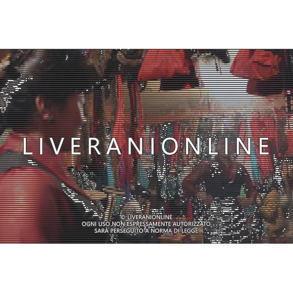 LHASA, May 9, 2011 An compere examines her dress at the dressing room of Niwei Langma Hall in Lhasa, capital of southwest China\'s Tibet Autonomous Region, May 5, 2011. It was 10:30 p.m. in Lhasa. Although most of the shops and restaurants were about to close, Niwei Langma hall was just warming up. Colorful spotlights illuminated the huge backdrop painting of the Potala Palace on the stage, while delightful Tibetan melody echoed around the hall. Guests were arriving in pairs or groups and quickly filled up the entertainment place. Dainzhencao, a newcome dancer, was busy dressing herself for the opening performance. She couldn\'t stop feeling nervous until she made sure her make up, costumes and decorations were all done, as she just danced this piece for a few times. However, at another dressing room, the experienced dancers were in an easy mood, as some were playing cell phone games, gossiping, and even knitting. The word \'Langma\' in Tibetan language means courtly performance, which in the past was only an entertainment for Tibetan traditional aristocracy. However, the present langma hall eventually evolved into a place of part bar, part folk concert hall and part ballroom, where common Tibetan people go for relaxation and gathering. Since the first such place opened in the mid 1990s, Langma halls soon became quite popular all over Tibet and emerged one after another in a short time. Today, Niwei is one of the biggest Langma halls in Lhasa. Its owner Gyaebo, who used to be a famous tap dancer in Lhasa, runs four langma halls of his own. All of his langma halls perform traditional Tibetan songs and dances, but in order to cater to different taste of customers, two langma halls emphasize on modern, western dance and even disco, while the others focus on Tibetan \'guozhuang\' and tap dance. There are more than 50 actors in Niwei Langma Hall, more than half of whom are at their 20\'s. They usually work for 5 6 hours per day, and attend two hour long r Scene di vita a Lhasa AG. ALDO LIVERANI SAS ITALY ONLY *** Local Caption *** .