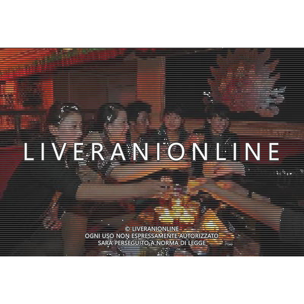 LHASA, May 9, 2011 A group of young people gather at the Niwei Langma Hall in Lhasa, capital of southwest China\'s Tibet Autonomous Region, early May 7, 2011. It was 10:30 p.m. in Lhasa. Although most of the shops and restaurants were about to close, Niwei Langma hall was just warming up. Colorful spotlights illuminated the huge backdrop painting of the Potala Palace on the stage, while delightful Tibetan melody echoed around the hall. Guests were arriving in pairs or groups and quickly filled up the entertainment place. Dainzhencao, a newcome dancer, was busy dressing herself for the opening performance. She couldn\'t stop feeling nervous until she made sure her make up, costumes and decorations were all done, as she just danced this piece for a few times. However, at another dressing room, the experienced dancers were in an easy mood, as some were playing cell phone games, gossiping, and even knitting. The word \'Langma\' in Tibetan language means courtly performance, which in the past was only an entertainment for Tibetan traditional aristocracy. However, the present langma hall eventually evolved into a place of part bar, part folk concert hall and part ballroom, where common Tibetan people go for relaxation and gathering. Since the first such place opened in the mid 1990s, Langma halls soon became quite popular all over Tibet and emerged one after another in a short time. Today, Niwei is one of the biggest Langma halls in Lhasa. Its owner Gyaebo, who used to be a famous tap dancer in Lhasa, runs four langma halls of his own. All of his langma halls perform traditional Tibetan songs and dances, but in order to cater to different taste of customers, two langma halls emphasize on modern, western dance and even disco, while the others focus on Tibetan \'guozhuang\' and tap dance. There are more than 50 actors in Niwei Langma Hall, more than half of whom are at their 20\'s. They usually work for 5 6 hours per day, and attend two hour long rehearsals Scene di vita a Lhasa AG. ALDO LIVERANI SAS ITALY ONLY *** Local Caption *** .