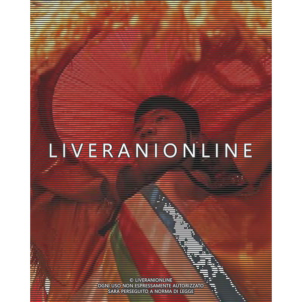 LHASA, May 9, 2011 Rinzin Dawa dresses himself at the dressing room of Niwei Langma Hall in Lhasa, capital of southwest China\'s Tibet Autonomous Region, May 6, 2011. It was 10:30 p.m. in Lhasa. Although most of the shops and restaurants were about to close, Niwei Langma hall was just warming up. Colorful spotlights illuminated the huge backdrop painting of the Potala Palace on the stage, while delightful Tibetan melody echoed around the hall. Guests were arriving in pairs or groups and quickly filled up the entertainment place. Dainzhencao, a newcome dancer, was busy dressing herself for the opening performance. She couldn\'t stop feeling nervous until she made sure her make up, costumes and decorations were all done, as she just danced this piece for a few times. However, at another dressing room, the experienced dancers were in an easy mood, as some were playing cell phone games, gossiping, and even knitting. The word \'Langma\' in Tibetan language means courtly performance, which in the past was only an entertainment for Tibetan traditional aristocracy. However, the present langma hall eventually evolved into a place of part bar, part folk concert hall and part ballroom, where common Tibetan people go for relaxation and gathering. Since the first such place opened in the mid 1990s, Langma halls soon became quite popular all over Tibet and emerged one after another in a short time. Today, Niwei is one of the biggest Langma halls in Lhasa. Its owner Gyaebo, who used to be a famous tap dancer in Lhasa, runs four langma halls of his own. All of his langma halls perform traditional Tibetan songs and dances, but in order to cater to different taste of customers, two langma halls emphasize on modern, western dance and even disco, while the others focus on Tibetan \'guozhuang\' and tap dance. There are more than 50 actors in Niwei Langma Hall, more than half of whom are at their 20\'s. They usually work for 5 6 hours per day, and attend two hour long reh Scene di vita a Lhasa AG. ALDO LIVERANI SAS ITALY ONLY *** Local Caption *** .