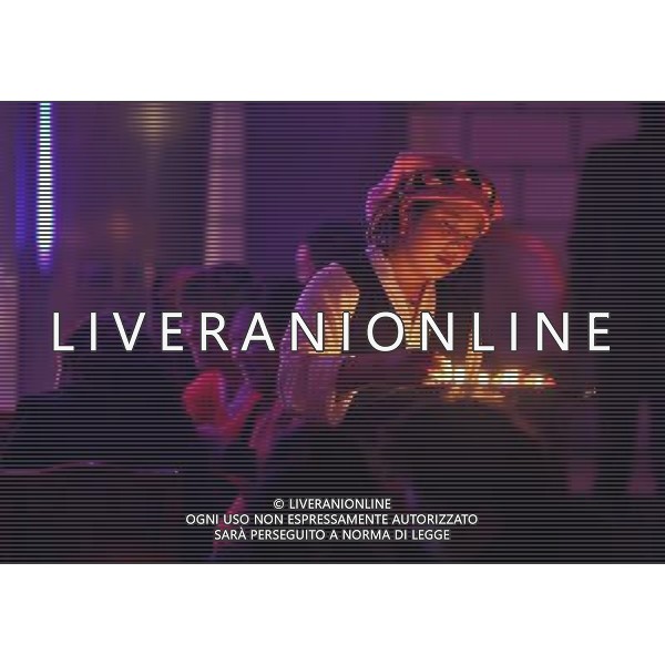 LHASA, May 9, 2011 A waitress brings guests candles at the New Century Langma Hall in Lhasa, capital of southwest China\'s Tibet Autonomous Region, early May 8, 2011. It was 10:30 p.m. in Lhasa. Although most of the shops and restaurants were about to close, Niwei Langma hall was just warming up. Colorful spotlights illuminated the huge backdrop painting of the Potala Palace on the stage, while delightful Tibetan melody echoed around the hall. Guests were arriving in pairs or groups and quickly filled up the entertainment place. Dainzhencao, a newcome dancer, was busy dressing herself for the opening performance. She couldn\'t stop feeling nervous until she made sure her make up, costumes and decorations were all done, as she just danced this piece for a few times. However, at another dressing room, the experienced dancers were in an easy mood, as some were playing cell phone games, gossiping, and even knitting. The word \'Langma\' in Tibetan language means courtly performance, which in the past was only an entertainment for Tibetan traditional aristocracy. However, the present langma hall eventually evolved into a place of part bar, part folk concert hall and part ballroom, where common Tibetan people go for relaxation and gathering. Since the first such place opened in the mid 1990s, Langma halls soon became quite popular all over Tibet and emerged one after another in a short time. Today, Niwei is one of the biggest Langma halls in Lhasa. Its owner Gyaebo, who used to be a famous tap dancer in Lhasa, runs four langma halls of his own. All of his langma halls perform traditional Tibetan songs and dances, but in order to cater to different taste of customers, two langma halls emphasize on modern, western dance and even disco, while the others focus on Tibetan \'guozhuang\' and tap dance. There are more than 50 actors in Niwei Langma Hall, more than half of whom are at their 20\'s. They usually work for 5 6 hours per day, and attend two hour long reh Scene di vita a Lhasa AG. ALDO LIVERANI SAS ITALY ONLY *** Local Caption *** .