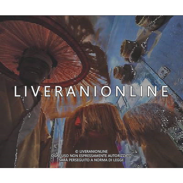 LHASA, May 9, 2011 Actors prepare at a dressing room of the Snowland Gyaebo Langma Hall in Lhasa, capital of southwest China\'s Tibet Autonomous Region, early May 6, 2011. It was 10:30 p.m. in Lhasa. Although most of the shops and restaurants were about to close, Niwei Langma hall was just warming up. Colorful spotlights illuminated the huge backdrop painting of the Potala Palace on the stage, while delightful Tibetan melody echoed around the hall. Guests were arriving in pairs or groups and quickly filled up the entertainment place. Dainzhencao, a newcome dancer, was busy dressing herself for the opening performance. She couldn\'t stop feeling nervous until she made sure her make up, costumes and decorations were all done, as she just danced this piece for a few times. However, at another dressing room, the experienced dancers were in an easy mood, as some were playing cell phone games, gossiping, and even knitting. The word \'Langma\' in Tibetan language means courtly performance, which in the past was only an entertainment for Tibetan traditional aristocracy. However, the present langma hall eventually evolved into a place of part bar, part folk concert hall and part ballroom, where common Tibetan people go for relaxation and gathering. Since the first such place opened in the mid 1990s, Langma halls soon became quite popular all over Tibet and emerged one after another in a short time. Today, Niwei is one of the biggest Langma halls in Lhasa. Its owner Gyaebo, who used to be a famous tap dancer in Lhasa, runs four langma halls of his own. All of his langma halls perform traditional Tibetan songs and dances, but in order to cater to different taste of customers, two langma halls emphasize on modern, western dance and even disco, while the others focus on Tibetan \'guozhuang\' and tap dance. There are more than 50 actors in Niwei Langma Hall, more than half of whom are at their 20\'s. They usually work for 5 6 hours per day, and attend two hour lon Scene di vita a Lhasa AG. ALDO LIVERANI SAS ITALY ONLY *** Local Caption *** .