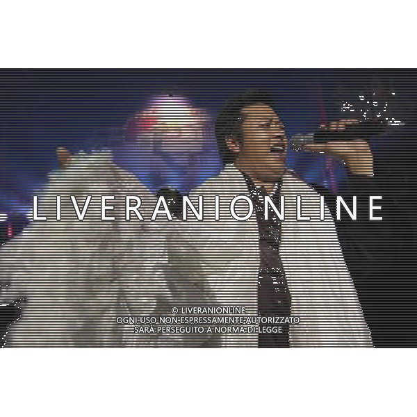 LHASA, May 9, 2011 Singer Gompo performs at the Niwei Langma Hall in Lhasa, capital of southwest China\'s Tibet Autonomous Region, early May 7, 2011. It was 10:30 p.m. in Lhasa. Although most of the shops and restaurants were about to close, Niwei Langma hall was just warming up. Colorful spotlights illuminated the huge backdrop painting of the Potala Palace on the stage, while delightful Tibetan melody echoed around the hall. Guests were arriving in pairs or groups and quickly filled up the entertainment place. Dainzhencao, a newcome dancer, was busy dressing herself for the opening performance. She couldn\'t stop feeling nervous until she made sure her make up, costumes and decorations were all done, as she just danced this piece for a few times. However, at another dressing room, the experienced dancers were in an easy mood, as some were playing cell phone games, gossiping, and even knitting. The word \'Langma\' in Tibetan language means courtly performance, which in the past was only an entertainment for Tibetan traditional aristocracy. However, the present langma hall eventually evolved into a place of part bar, part folk concert hall and part ballroom, where common Tibetan people go for relaxation and gathering. Since the first such place opened in the mid 1990s, Langma halls soon became quite popular all over Tibet and emerged one after another in a short time. Today, Niwei is one of the biggest Langma halls in Lhasa. Its owner Gyaebo, who used to be a famous tap dancer in Lhasa, runs four langma halls of his own. All of his langma halls perform traditional Tibetan songs and dances, but in order to cater to different taste of customers, two langma halls emphasize on modern, western dance and even disco, while the others focus on Tibetan \'guozhuang\' and tap dance. There are more than 50 actors in Niwei Langma Hall, more than half of whom are at their 20\'s. They usually work for 5 6 hours per day, and attend two hour long rehearsals for 3 4 t Scene di vita a Lhasa AG. ALDO LIVERANI SAS ITALY ONLY *** Local Caption *** .