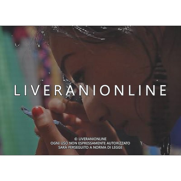 LHASA, May 9, 2011 Dainzhencao puts on make up before the show at the Niwei Langma Hall in Lhasa, capital of southwest China\'s Tibet Autonomous Region, May 5, 2011. It was 10:30 p.m. in Lhasa. Although most of the shops and restaurants were about to close, Niwei Langma hall was just warming up. Colorful spotlights illuminated the huge backdrop painting of the Potala Palace on the stage, while delightful Tibetan melody echoed around the hall. Guests were arriving in pairs or groups and quickly filled up the entertainment place. Dainzhencao, a newcome dancer, was busy dressing herself for the opening performance. She couldn\'t stop feeling nervous until she made sure her make up, costumes and decorations were all done, as she just danced this piece for a few times. However, at another dressing room, the experienced dancers were in an easy mood, as some were playing cell phone games, gossiping, and even knitting. The word \'Langma\' in Tibetan language means courtly performance, which in the past was only an entertainment for Tibetan traditional aristocracy. However, the present langma hall eventually evolved into a place of part bar, part folk concert hall and part ballroom, where common Tibetan people go for relaxation and gathering. Since the first such place opened in the mid 1990s, Langma halls soon became quite popular all over Tibet and emerged one after another in a short time. Today, Niwei is one of the biggest Langma halls in Lhasa. Its owner Gyaebo, who used to be a famous tap dancer in Lhasa, runs four langma halls of his own. All of his langma halls perform traditional Tibetan songs and dances, but in order to cater to different taste of customers, two langma halls emphasize on modern, western dance and even disco, while the others focus on Tibetan \'guozhuang\' and tap dance. There are more than 50 actors in Niwei Langma Hall, more than half of whom are at their 20\'s. They usually work for 5 6 hours per day, and attend two hour long rehe Scene di vita a Lhasa AG. ALDO LIVERANI SAS ITALY ONLY *** Local Caption *** .