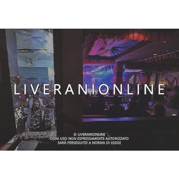 LHASA, May 9, 2011 Actors prepare to go upon stage at the Snowland Gyaebo Langma Hall in Lhasa, capital of southwest China\'s Tibet Autonomous Region, early May 6, 2011. It was 10:30 p.m. in Lhasa. Although most of the shops and restaurants were about to close, Niwei Langma hall was just warming up. Colorful spotlights illuminated the huge backdrop painting of the Potala Palace on the stage, while delightful Tibetan melody echoed around the hall. Guests were arriving in pairs or groups and quickly filled up the entertainment place. Dainzhencao, a newcome dancer, was busy dressing herself for the opening performance. She couldn\'t stop feeling nervous until she made sure her make up, costumes and decorations were all done, as she just danced this piece for a few times. However, at another dressing room, the experienced dancers were in an easy mood, as some were playing cell phone games, gossiping, and even knitting. The word \'Langma\' in Tibetan language means courtly performance, which in the past was only an entertainment for Tibetan traditional aristocracy. However, the present langma hall eventually evolved into a place of part bar, part folk concert hall and part ballroom, where common Tibetan people go for relaxation and gathering. Since the first such place opened in the mid 1990s, Langma halls soon became quite popular all over Tibet and emerged one after another in a short time. Today, Niwei is one of the biggest Langma halls in Lhasa. Its owner Gyaebo, who used to be a famous tap dancer in Lhasa, runs four langma halls of his own. All of his langma halls perform traditional Tibetan songs and dances, but in order to cater to different taste of customers, two langma halls emphasize on modern, western dance and even disco, while the others focus on Tibetan \'guozhuang\' and tap dance. There are more than 50 actors in Niwei Langma Hall, more than half of whom are at their 20\'s. They usually work for 5 6 hours per day, and attend two hour long Scene di vita a Lhasa AG. ALDO LIVERANI SAS ITALY ONLY *** Local Caption *** .