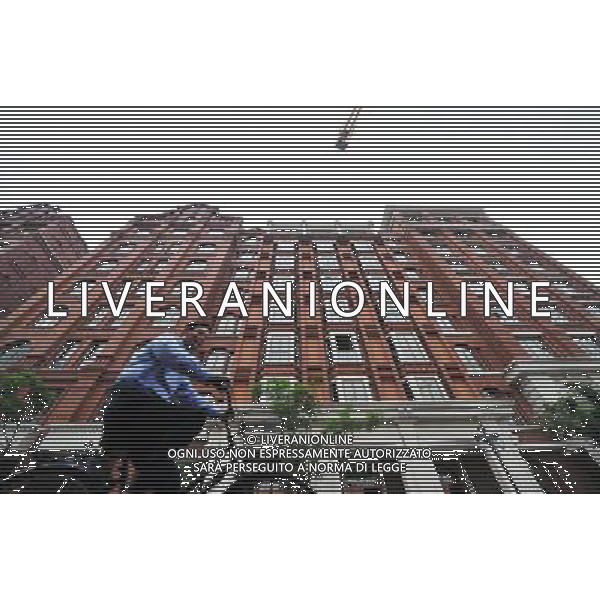 TIANJIN, May 10, 2011 A citizen passes by a building on Tai\'an Road in Tianjin Municipality, north China, May 9, 2011. Located in the middle of original British concession, Tai\'an road has more than 100 years history, with The Astor Hotel, Victoria Garden and Anglican Church sitting along it. A district with British characters has taken shape after three buildings was basically completed in the Taian Road in Tianjin. (/Qiu Yuewei)(yrz) Citta\' di Tianjin , scorcio con vista sui pricipali monumenti ed edifici storici AG. ALDO LIVERANI SAS ITALY ONLY *** Local Caption *** .