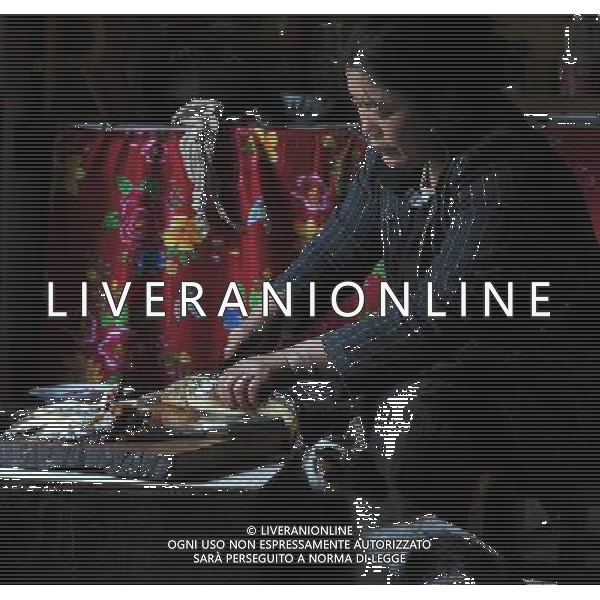 (110517) -- BEIJING, May 17, 2011 () -- Ya Niang, a villager of Lhoba ethnic group, prepares dinner at her house in Qionglin Village of Nanyi Lhoba Ethnic Township, in Mainling County of southwest China\'s Tibet Autonomous Region (TAR), May 11, 2011. Located at the foot of snow-peaked mountains near the south border between China and India, the Nanyi Township of Qionglin Village, a tranquil and picturesque place, is inhabited by people of Lhoba ethnic group. With a total of 2900 people, Lhoba ethnic group is the smallest among China\'s 56 ethnic groups in term of population. The family of forty-six-year-old Ma Ya is one of the 30 Lhoba households in the village. They live in a two-storeyed house with many modern devices like television, washing machine, refrigerator, etc. In 2008, his family opened a household inn when Qionglin Village set up a scenic area. Their family inn soon went popular among tourists, and earned them about 6,000 yuan (922 U. S. dollars) per month at the tourism peak season from June to October. Yet just 50 years ago, before Ma Ya\'s birth, his father and grandfather still lived in the wood, depending mainly on hunting with bows and arrows, in the very form of a primitive society. As few knew their existence in the wildest nature, they were dubbed as \'the tribe of mystery\'. In the 1960s, after the peaceful liberation of Tibet, Ma Ya\'s father and some other Lhoba people moved out of the wood and settled on a land offered by the local government. By 1985, all the Lhoba people of the village have moved into free dwelling houses and started to breed livestock provided by the government, thus marking the brand-new start of their modern life. Instead of hunting and logging, their previous livelihood, local villagers of Lhoba now earn their living on stockbreeding, bamboo weaving, herbal medicine picking, and tourism. Under the benefits of many national policies preferential for minority groups, the annual income per capita of Nanyi Towns Situato ai piedi delle montagne innevate, vicino al confine meridionale tra la Cina e l\'India, il Comune di Nanyi Qionglin Village, un luogo pittoresco e tranquillo, abitato da persone del gruppo etnico Lhoba. Con un totale di 2900 persone, il gruppo etnico Lhoba  il pi piccolo dei 56 gruppi etnici in termini di popolazione in Cina Etnie - Vita - Rurali - AG. ALDO LIVERANI SAS ITALY ONLY *** Local Caption *** .