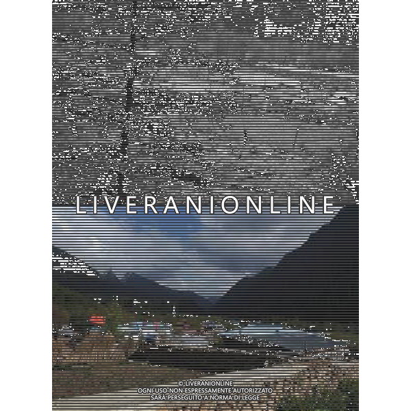 (110517) -- BEIJING, May 17, 2011 () -- This combo photo shows the previous Qionglin Village (above, taken on May 3, 1984) and the new village (bottom, taken on May 12, 2011). Located at the foot of snow-peaked mountains near the south border between China and India, the Nanyi Township of Qionglin Village, a tranquil and picturesque place, is inhabited by people of Lhoba ethnic group. With a total of 2900 people, Lhoba ethnic group is the smallest among China\'s 56 ethnic groups in term of population. The family of forty-six-year-old Ma Ya is one of the 30 Lhoba households in the village. They live in a two-storeyed house with many modern devices like television, washing machine, refrigerator, etc. In 2008, his family opened a household inn when Qionglin Village set up a scenic area. Their family inn soon went popular among tourists, and earned them about 6,000 yuan (922 U. S. dollars) per month at the tourism peak season from June to October. Yet just 50 years ago, before Ma Ya\'s birth, his father and grandfather still lived in the wood, depending mainly on hunting with bows and arrows, in the very form of a primitive society. As few knew their existence in the wildest nature, they were dubbed as \'the tribe of mystery\'. In the 1960s, after the peaceful liberation of Tibet, Ma Ya\'s father and some other Lhoba people moved out of the wood and settled on a land offered by the local government. By 1985, all the Lhoba people of the village have moved into free dwelling houses and started to breed livestock provided by the government, thus marking the brand-new start of their modern life. Instead of hunting and logging, their previous livelihood, local villagers of Lhoba now earn their living on stockbreeding, bamboo weaving, herbal medicine picking, and tourism. Under the benefits of many national policies preferential for minority groups, the annual income per capita of Nanyi Township reached 5760 yuan (885 U.S. dollars) in 2010. \'Before we moved here, mo Situato ai piedi delle montagne innevate, vicino al confine meridionale tra la Cina e l\'India, il Comune di Nanyi Qionglin Village, un luogo pittoresco e tranquillo, abitato da persone del gruppo etnico Lhoba. Con un totale di 2900 persone, il gruppo etnico Lhoba  il pi piccolo dei 56 gruppi etnici in termini di popolazione in Cina Etnie - Vita - Rurali - AG. ALDO LIVERANI SAS ITALY ONLY *** Local Caption *** .