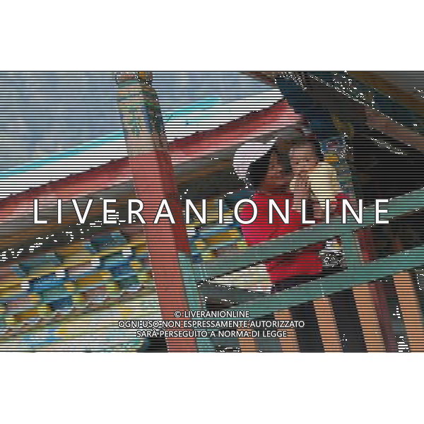 (110517) -- BEIJING, May 17, 2011 () -- Villager Ya Ying of Lhoba ethnic group plays with a baby at her house in Qionglin Village of Nanyi Lhoba Ethnic Township, in Mainling County of southwest China\'s Tibet Autonomous Region (TAR), May 12, 2011. Located at the foot of snow-peaked mountains near the south border between China and India, the Nanyi Township of Qionglin Village, a tranquil and picturesque place, is inhabited by people of Lhoba ethnic group. With a total of 2900 people, Lhoba ethnic group is the smallest among China\'s 56 ethnic groups in term of population. The family of forty-six-year-old Ma Ya is one of the 30 Lhoba households in the village. They live in a two-storeyed house with many modern devices like television, washing machine, refrigerator, etc. In 2008, his family opened a household inn when Qionglin Village set up a scenic area. Their family inn soon went popular among tourists, and earned them about 6,000 yuan (922 U. S. dollars) per month at the tourism peak season from June to October. Yet just 50 years ago, before Ma Ya\'s birth, his father and grandfather still lived in the wood, depending mainly on hunting with bows and arrows, in the very form of a primitive society. As few knew their existence in the wildest nature, they were dubbed as \'the tribe of mystery\'. In the 1960s, after the peaceful liberation of Tibet, Ma Ya\'s father and some other Lhoba people moved out of the wood and settled on a land offered by the local government. By 1985, all the Lhoba people of the village have moved into free dwelling houses and started to breed livestock provided by the government, thus marking the brand-new start of their modern life. Instead of hunting and logging, their previous livelihood, local villagers of Lhoba now earn their living on stockbreeding, bamboo weaving, herbal medicine picking, and tourism. Under the benefits of many national policies preferential for minority groups, the annual income per capita of Nanyi Townshi Situato ai piedi delle montagne innevate, vicino al confine meridionale tra la Cina e l\'India, il Comune di Nanyi Qionglin Village, un luogo pittoresco e tranquillo, abitato da persone del gruppo etnico Lhoba. Con un totale di 2900 persone, il gruppo etnico Lhoba  il pi piccolo dei 56 gruppi etnici in termini di popolazione in Cina Etnie - Vita - Rurali - AG. ALDO LIVERANI SAS ITALY ONLY *** Local Caption *** .