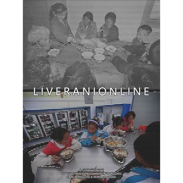 (110517) -- BEIJING, May 17, 2011 () -- This combo photo shows the previous dinning hall of Nanyi Lhoba Primary School (above, taken on May 9, 1992) and the new one (bottom, taken on May 11, 2011). Located at the foot of snow-peaked mountains near the south border between China and India, the Nanyi Township of Qionglin Village, a tranquil and picturesque place, is inhabited by people of Lhoba ethnic group. With a total of 2900 people, Lhoba ethnic group is the smallest among China\'s 56 ethnic groups in term of population. The family of forty-six-year-old Ma Ya is one of the 30 Lhoba households in the village. They live in a two-storeyed house with many modern devices like television, washing machine, refrigerator, etc. In 2008, his family opened a household inn when Qionglin Village set up a scenic area. Their family inn soon went popular among tourists, and earned them about 6,000 yuan (922 U. S. dollars) per month at the tourism peak season from June to October. Yet just 50 years ago, before Ma Ya\'s birth, his father and grandfather still lived in the wood, depending mainly on hunting with bows and arrows, in the very form of a primitive society. As few knew their existence in the wildest nature, they were dubbed as \'the tribe of mystery\'. In the 1960s, after the peaceful liberation of Tibet, Ma Ya\'s father and some other Lhoba people moved out of the wood and settled on a land offered by the local government. By 1985, all the Lhoba people of the village have moved into free dwelling houses and started to breed livestock provided by the government, thus marking the brand-new start of their modern life. Instead of hunting and logging, their previous livelihood, local villagers of Lhoba now earn their living on stockbreeding, bamboo weaving, herbal medicine picking, and tourism. Under the benefits of many national policies preferential for minority groups, the annual income per capita of Nanyi Township reached 5760 yuan (885 U.S. dollars) in 2010. Situato ai piedi delle montagne innevate, vicino al confine meridionale tra la Cina e l\'India, il Comune di Nanyi Qionglin Village, un luogo pittoresco e tranquillo, abitato da persone del gruppo etnico Lhoba. Con un totale di 2900 persone, il gruppo etnico Lhoba  il pi piccolo dei 56 gruppi etnici in termini di popolazione in Cina Etnie - Vita - Rurali - AG. ALDO LIVERANI SAS ITALY ONLY *** Local Caption *** .