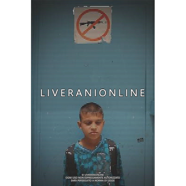 (110518) -- BETHLEHEM, May 18, 2011 () -- A Palestinian boy stands in front of a sign of forbidding the use of weapons on the school gate in a refugee camp in the West Bank city of Bethlehem, May 18, 2011. May 15, 1948 is the day of the creation of Israel, but of \'Nakba\' (catastrophe) for Palestinians who were displaced ever since and have lived in the West Bank, Gaza Strip, Jordan, Syria and Lebanon. Children who were born in the refugee camps suffer both physically and psychologically during their miserable childhood. (/Chen Xu) Bimbini in un campo profughi nella cittö cisgiordana di Betlemme AG. ALDO LIVERANI SAS ITALY ONLY *** Local Caption *** .