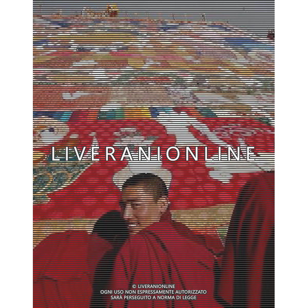 (110522) -- LHASA, May 22, 2011 () -- File photo taken on Aug. 27, 2003 shows a monk smiling while attending the ceremony to unfold a huge Buddha Tangka painting during the annual traditional Shoton (Yogurt) Festival in Zhaibung Monastery on the outskirts of Lhasa, capital of southwest China\'s Tibet Autonomous Region. Over the past 60 years, the Tibetan and other ethnic minorities living in the region have preserved their traditional garments and ornaments, diet and housing styles, and devoted their heart and soul to their beliefs. Compared with the population of Muslims and Catholics in Tibet, the Tibetan Buddhism devotees dominate the region. Tibet has more than 1,700 monasteries, which accommodate 46,000 lamas and nuns, accounting for about 2 percent of Tibet\'s population. But most of the three million people in the region are active Buddhists, who worship and practice religious rituals at home. The transmission lineage system of the reincarnation of a great lama after his death is unique to Tibetan Buddhism, and this has been respected by the state and governments at all levels in Tibet. In addition, many other religious activities and rites are also rich in content and diverse in form. The Tibetan ethics keep their custom to celebrate the Tibetan New Year, Bathing Festival, Ongkor (Bumper Harvest) Festival, Butter Lamp Festival, Dharma Festival, Burning Offerings Festival, Garchachen Festival and horse race fairs. Meanwhile, some modern events, like the Yarlung Art Festival in Shannan, Khampa Art Festival at Qamdo and so on, have also brought into being. The beauty and mystery of Tibet has embraced visitors worldwide and boomed in its tourism. () (hdt) Tradizioni del popolo Tibetano AG. ALDO LIVERANI SAS ITALY ONLY *** Local Caption *** .