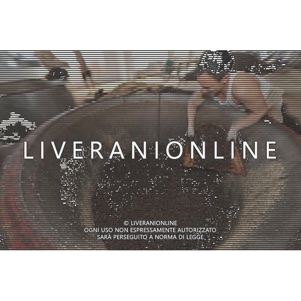 RENHUAI, May 26, 2011 A worker pours ferment materials into at a plant of Moutai Co. Ltd. in Maotai Township of Renhuai, southwest China\'s Guizhou Province, May 17, 2011. Maotai is a small town in Renhuai City of Zunyi, southwest China\'s Guizhou Province. Liquor making can be dated back to 2,000 years ago in the small town. There are many anecdotes about the liquor. During the Long March, the Chinese Red Army passed through Maotai Town in 1935, and used the hard liquor to treat the wounds of soldiers. In January 1935, an enlarged meeting of the Political Bureau of the Communist Party of China (CPC) Central Committee was held in Zunyi, the place where Mao Zedong established his authority within the military, marking a turning point for the CPC and paving the way for the success of China\'s revolution. With deep affection to the liquor, Chinese leaders honored Moutai as the national liquor after the founding of the People\'s Republic of China. Moutai liquor was officially used to feast foreign heads of state and distinguished guests visiting China, and was the only alcohol given as official gifts by Chinese embassies in foreign countries. It is said that former U.S. President Richard Nixon was fascinated by Moutai liquor when he visited China in 1972. As China moves from a planned to a market economy, the Moutai brewery has developed into one of China\'s handful of leading liquor producers with conspicuous achievements in modern corporate management and construction of factory facilities. In 2010, the annual output of Moutai liquor topped 26,000 tons. However, the market supply and demand of the liquor is imbalanced because of its special manufacturing techniques. Prices of the liquor range from 1,000 RMB yuan (about 154 U.S. dollars) to more than 10,000 RMB yuan (about 1,541 U.S. dollars) per bottle. In April, a bottle of vintage Moutai was sold for 8.9 million RMB yuan (about 1.37 million U.S. dollars) at an auction in Guizhou, while the price of Moutai liquor