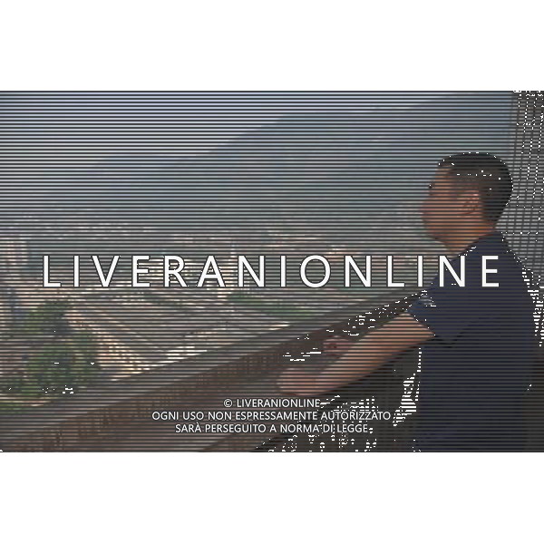 RENHUAI, May 26, 2011 Chen Wei, husband of the granddaughter of the 76 year old Moutai retired worker Hu Shixian, overlooks the plant zone of Moutai Co. Ltd. in Maotai Township of Renhuai, southwest China\'s Guizhou Province, May 18, 2011. A total of 19 members of Hu\'s family have worked in the distillery. Maotai is a small town in Renhuai City of Zunyi, southwest China\'s Guizhou Province. Liquor making can be dated back to 2,000 years ago in the small town. There are many anecdotes about the liquor. During the Long March, the Chinese Red Army passed through Maotai Town in 1935, and used the hard liquor to treat the wounds of soldiers. In January 1935, an enlarged meeting of the Political Bureau of the Communist Party of China (CPC) Central Committee was held in Zunyi, the place where Mao Zedong established his authority within the military, marking a turning point for the CPC and paving the way for the success of China\'s revolution. With deep affection to the liquor, Chinese leaders honored Moutai as the national liquor after the founding of the People\'s Republic of China. Moutai liquor was officially used to feast foreign heads of state and distinguished guests visiting China, and was the only alcohol given as official gifts by Chinese embassies in foreign countries. It is said that former U.S. President Richard Nixon was fascinated by Moutai liquor when he visited China in 1972. As China moves from a planned to a market economy, the Moutai brewery has developed into one of China\'s handful of leading liquor producers with conspicuous achievements in modern corporate management and construction of factory facilities. In 2010, the annual output of Moutai liquor topped 26,000 tons. However, the market supply and demand of the liquor is imbalanced because of its special manufacturing techniques. Prices of the liquor range from 1,000 RMB yuan (about 154 U.S. dollars) to more than 10,000 RMB yuan (about 1,541 U.S. dollars) per bottle. In April, a bottle of vinta