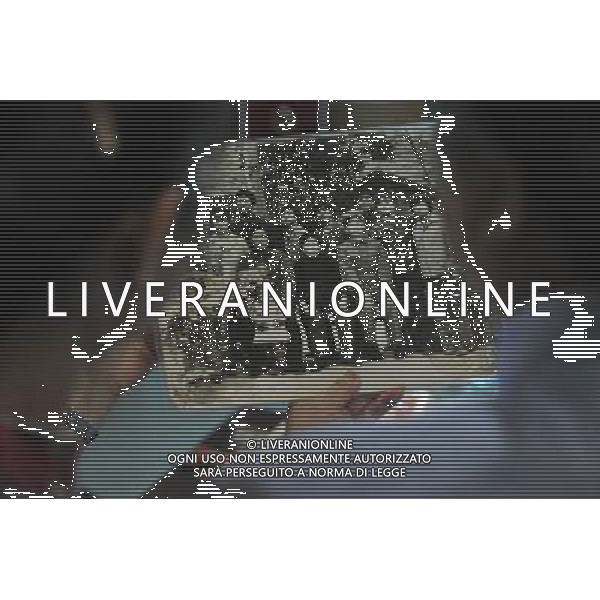 (110526) -- RENHUAI, May 26, 2011 () -- The 76-year-old Hu Shixian (R), a retired worker of Moutai distillery, looks at a group photo of her family taken in the distillery, at her home in Maotai Township of Renhuai, southwest China\'s Guizhou Province, May 18, 2011. A total of 19 members of Hu\'s family have worked in the distillery. Maotai is a small town in Renhuai City of Zunyi, southwest China\'s Guizhou Province. Liquor-making can be dated back to 2,000 years ago in the small town. There are many anecdotes about the liquor. During the Long March, the Chinese Red Army passed through Maotai Town in 1935, and used the hard liquor to treat the wounds of soldiers. In January 1935, an enlarged meeting of the Political Bureau of the Communist Party of China (CPC) Central Committee was held in Zunyi, the place where Mao Zedong established his authority within the military, marking a turning point for the CPC and paving the way for the success of China\'s revolution. With deep affection to the liquor, Chinese leaders honored Moutai as the national liquor after the founding of the People\'s Republic of China. Moutai liquor was officially used to feast foreign heads of state and distinguished guests visiting China, and was the only alcohol given as official gifts by Chinese embassies in foreign countries. It is said that former U.S. President Richard Nixon was fascinated by Moutai liquor when he visited China in 1972. As China moves from a planned to a market economy, the Moutai brewery has developed into one of China\'s handful of leading liquor producers with conspicuous achievements in modern corporate management and construction of factory facilities. In 2010, the annual output of Moutai liquor topped 26,000 tons. However, the market supply and demand of the liquor is imbalanced because of its special manufacturing techniques. Prices of the liquor range from 1,000 RMB yuan (about 154 U.S. dollars) to more than 10,000 RMB yuan (about 1,541 U.S. dollars) per bottle.