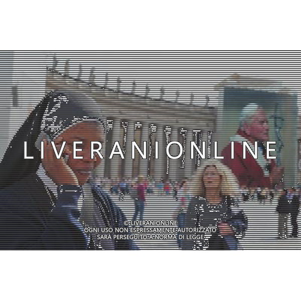 A Catholic nun making a phone call on here mobile near a giant banner bearing John Paul\'s portrait is unveiled over the facade of St Peter\'s basilica during the ceremony of beatification for late pope John Paul II on May 1, 2011 at St Peter\'s square at The Vatican. Photo by NEWSCOM OUT AG ALDO LIVERANI S A S