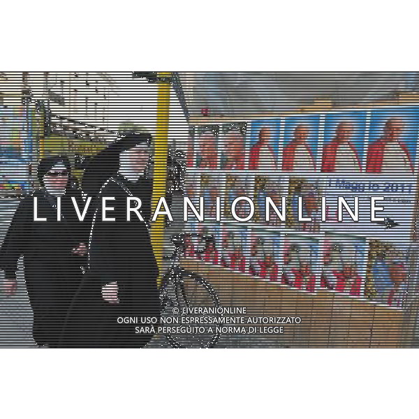 A Catholic nuns are looking at a giant banner bearing John Paul\'s portrait is unveiled over the facade of St Peter\'s basilica during the ceremony of beatification for late pope John Paul II on May 1, 2011 at St Peter\'s square at The Vatican. Photo by NEWSCOM OUT AG ALDO LIVERANI S A S