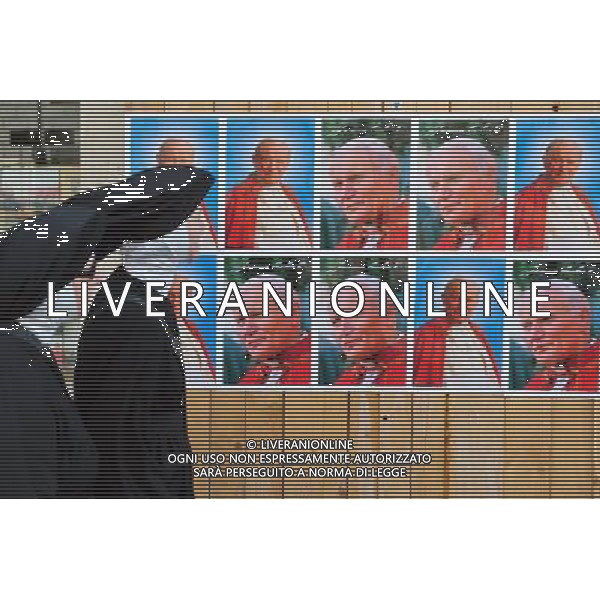 A Catholic nuns are looking at a giant banner bearing John Paul\'s portrait is unveiled over the facade of St Peter\'s basilica during the ceremony of beatification for late pope John Paul II on May 1, 2011 at St Peter\'s square at The Vatican. Photo by NEWSCOM OUT AG ALDO LIVERANI S A S