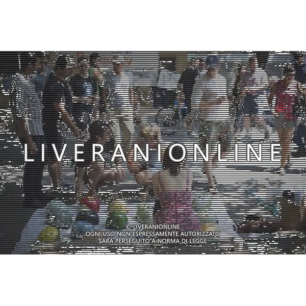 People shop for bike helmets in Williamsburg in Brooklyn in New York on Saturday, May 28, 2011at the Seventh Annual Bicycle Fetish Day. Bike enthusiasts showed off their customized, expensive or old school bicycles to other bike lovers while they competed for prizes and purchased goods from vendors catering to them. ©photoshot/Agenzia Aldo Liverani Sas - ITALY ONLY - Gli abitanti e Turisti a New York affollano la citta\' nell\'inizio non ufficiale dell\'estate