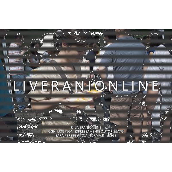 Visitors to the Passport to Taiwan festival in Union Square Park in New York on Sunday, May 29, 2011 eat traditional dishes of shaved ice with mango topping, perfect for the hot, humid day. The festival, now in its ninth year, promotes the food and culture of Taiwan with music and crafts and is an important event in the Taiwanese-American community in the New York tri-state area. ©photoshot/Agenzia Aldo Liverani Sas - ITALY ONLY - Gli abitanti e Turisti a New York affollano la citta\' nell\'inizio non ufficiale dell\'estate