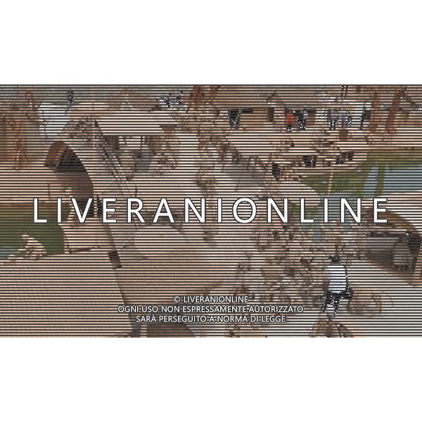 TANGSHAN, June 3, 2011 A visitor takes pictures among figurines in a clay sculpture park built to simulate the scene in a renowned Chinese scroll painting \'Riverside Scene on the Qingming Festival\' in Changzhuang Township, Tangshan City of north China\'s Hebei Province, June 3, 2011. The park, with hundreds of handmade sculptures, was officially open to the public on Friday. (/Yan Jun) (hdt) parco di sculture di argilla fatte a mano costruite per simulare la scena di un famoso rotolo cinese dipinto \'Riverside Scene sul Festival Qingming\' in Changzhuang Township, cittö di Tangshan del nord della Cina AG. ALDO LIVERANI SAS ITALY ONLY *** Local Caption *** .