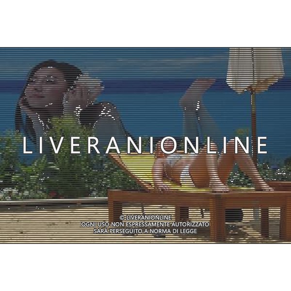 SHANGHAI, June 9, 2011 A tourist enjoys the sun bath on the man made beach in Shanghai, east China, June 9, 2011. Local weather station issued a high temperature warning on Thursday. The high temperature in Shanghai on Thursday reached 37 degrees centigrade. (zhs) Turisti si godono il sole su una spiaggia artificiale a Shanghai, Cina orientale - Sabbia - Sdraio - Abbronzarsi - AG. ALDO LIVERANI SAS - ITALY ONLY *** Local Caption *** .