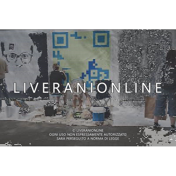 Todd Cruikshank, left, with an assistant works on his QR code inspired canvas at the Howl! Festival\'s \'Art Around the Park\' around Tompkins Square Park in New York\'s East Village. on Saturday, June 4, 2011. The festival, named after poet Allen Ginsberg\'s famous poem, celebrates the arts in the East Village and also consists of other events including performances and poetry readings. The artists are given canvas\' around the perimeter of the park where they work in public view, as a sort of counter-cultural Washington Square Art Show. (å© Richard B. Levine) /PHOTOSHOT/AG ALDO LIVERANI SAS - ITALY ONLY - *** Local Caption *** .