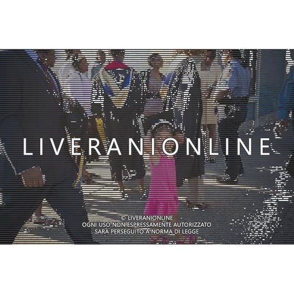 A little girl wears a graduate\'s graduation cap outside of the Jacob Javits Convention Center in New York after the 45th commencement exercises of John Jay College of Criminal Justice,The City University of New York, on Friday, June 3, 2011. (å© Frances M. Roberts) /PHOTOSHOT/AG ALDO LIVERANI SAS - ITALY ONLY - *** Local Caption *** .