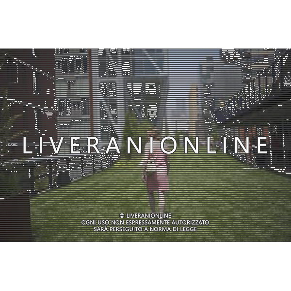 Visitors enjoy the Great Lawn area on opening day of the second phase, from West 20th Street to West 30th Street, of the High Line Park in Chelsea is seen on Tuesday, June 7, 2011. The new section includes the 4900 square foot lawn for visitors to sit and sunbathe as well as a \'flyover\' walkway that raises you eight feet above the foliage. Since the first section opened millions of dollars in real estate has been developed along the park. (å© Frances M. Roberts) /PHOTOSHOT/AG ALDO LIVERANI SAS - ITALY ONLY - *** Local Caption *** .