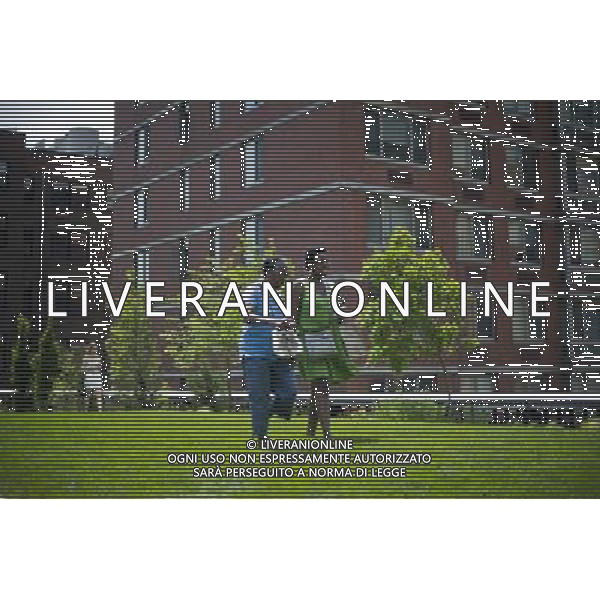 Visitors enjoy the Great Lawn area on opening day of the second phase, from West 20th Street to West 30th Street, of the High Line Park in Chelsea is seen on Tuesday, June 7, 2011. The new section includes the 4900 square foot lawn for visitors to sit and sunbathe as well as a \'flyover\' walkway that raises you eight feet above the foliage. Since the first section opened millions of dollars in real estate has been developed along the park. (å© Frances M. Roberts) /PHOTOSHOT/AG ALDO LIVERANI SAS - ITALY ONLY - *** Local Caption *** .