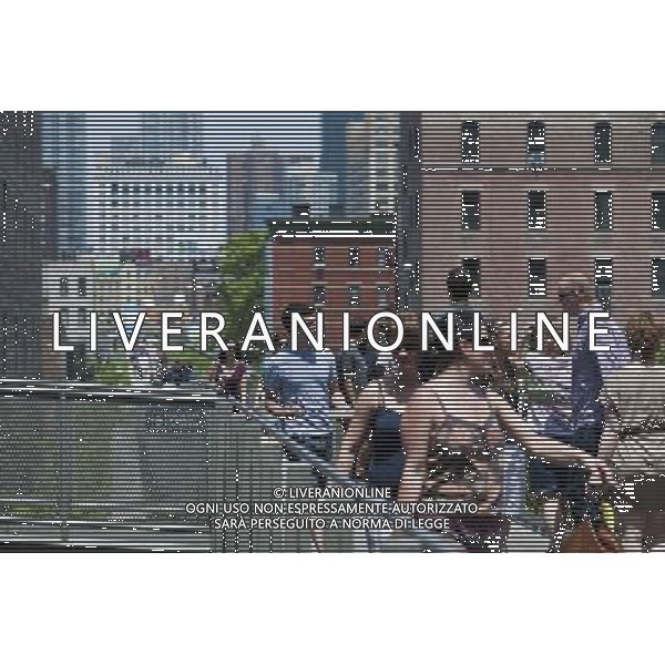 Opening day of the second phase, from West 20th Street to West 30th Street, of the High Line Park in Chelsea is seen on Tuesday, June 7, 2011. The new section includes a lawn for visitors to sit and sunbathe as well as a \'flyover\' walkway that raises you eight feet above the foliage. Since the first section opened millions of dollars in real estate has been developed along the park. (Œ© Richard B. Levine) /PHOTOSHOT/AG ALDO LIVERANI SAS - ITALY ONLY - *** Local Caption *** .